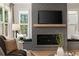 Cozy living room features a modern fireplace, built-in window seats, and large windows offering natural light at 2553 Creekwood Ter, Decatur, GA 30030