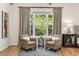 Cozy sitting area inside the main bedroom with leather chairs and a large window providing ample light at 2553 Creekwood Ter, Decatur, GA 30030