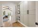 Walk-in closet leading to a main bedroom with vaulted ceiling, fan, and backyard views at 2553 Creekwood Ter, Decatur, GA 30030