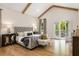 This primary bedroom offers a vaulted ceiling, hardwood floors, and deck access through French doors at 2553 Creekwood Ter, Decatur, GA 30030