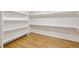 Walk-in closet with custom shelving and hardwood floors at 2553 Creekwood Ter, Decatur, GA 30030