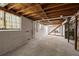 Unfinished basement space featuring concrete floors and walls, with exposed beams and stairs at 470 Hunnicutt Se Rd, Mableton, GA 30126