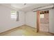Unfinished basement space featuring concrete flooring, white brick walls and natural light from a window at 470 Hunnicutt Se Rd, Mableton, GA 30126