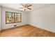 Bright bedroom with hardwood floors and a large window offering a view of the landscaped yard at 470 Hunnicutt Se Rd, Mableton, GA 30126