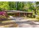 Charming brick home with a covered parking area and lush, mature landscaping in a serene, wooded setting at 470 Hunnicutt Se Rd, Mableton, GA 30126
