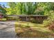 Traditional brick home with a porte-cochere, inviting front entrance, and a well-maintained lawn at 470 Hunnicutt Se Rd, Mableton, GA 30126