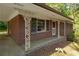 The red brick exterior home boasts detailed porch columns and a covered entryway, providing curb appeal at 470 Hunnicutt Se Rd, Mableton, GA 30126