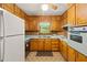 Nostalgic kitchen with wooden cabinetry, retro appliances, and a window providing natural light at 470 Hunnicutt Se Rd, Mableton, GA 30126