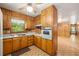 Vintage kitchen equipped with wood cabinets, linoleum floors, and classic appliances, leading to additional rooms at 470 Hunnicutt Se Rd, Mableton, GA 30126