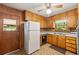 Retro kitchen featuring wood cabinets, vintage appliances, a ceiling fan, and linoleum flooring at 470 Hunnicutt Se Rd, Mableton, GA 30126