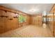 Inviting living room with wood paneled walls, a window, and a decorative ceiling light fixture at 470 Hunnicutt Se Rd, Mableton, GA 30126