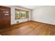 Bright living room featuring hardwood floors, a wooden door, and a large window with scenic outdoor views at 470 Hunnicutt Se Rd, Mableton, GA 30126