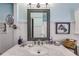 Bright bathroom with marble countertops, a mirror, and decorative accents at 1189 Norfolk Nw Dr, Acworth, GA 30102