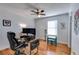 Comfortable bedroom featuring hardwood floors, a ceiling fan and a window for natural light at 1189 Norfolk Nw Dr, Acworth, GA 30102