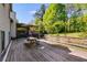 Large wooden deck with a picnic table, perfect for outdoor dining and relaxing at 1189 Norfolk Nw Dr, Acworth, GA 30102