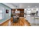 Open kitchen and dining area with light blue walls, stainless appliances, and hardwood floors at 1189 Norfolk Nw Dr, Acworth, GA 30102