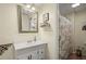 Cozy bathroom featuring a single sink vanity, framed mirror, and shower with decorative curtain at 2870 Abbottswell Dr, Alpharetta, GA 30022