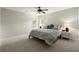 Spacious bedroom with plush carpet, ceiling fan and natural light from windows at 2870 Abbottswell Dr, Alpharetta, GA 30022