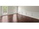 Bright dining room featuring hardwood floors, wainscoting, and natural light from large windows at 2870 Abbottswell Dr, Alpharetta, GA 30022