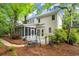 Back of the home with a screened in porch and beautiful natural landscaping at 2870 Abbottswell Dr, Alpharetta, GA 30022