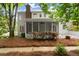Back of house featuring a screened in porch, lush lawn, and mature landscaping at 2870 Abbottswell Dr, Alpharetta, GA 30022