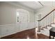 Elegant foyer featuring a staircase, hardwood floors, and beautiful molding detail around the entry door at 2870 Abbottswell Dr, Alpharetta, GA 30022
