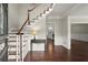 Inviting foyer featuring a staircase, hardwood floors, and an entry table with views into adjacent living spaces at 2870 Abbottswell Dr, Alpharetta, GA 30022