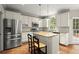 Bright, updated kitchen featuring white cabinets, granite countertops, stainless steel appliances, and an island with seating at 2870 Abbottswell Dr, Alpharetta, GA 30022