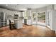 Bright, updated kitchen featuring white cabinets, granite countertops, stainless steel appliances, and access to outdoors at 2870 Abbottswell Dr, Alpharetta, GA 30022