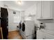 Functional laundry room equipped with a washer, dryer, sink, and storage cabinets, maximizing convenience and organization at 2870 Abbottswell Dr, Alpharetta, GA 30022