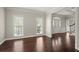 Spacious living room featuring hardwood floors, large windows, and an open layout leading to the foyer at 2870 Abbottswell Dr, Alpharetta, GA 30022