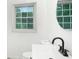 Bright bathroom with a large window, modern sink and black faucet at 3132 Lunsford Cir, Covington, GA 30014