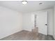 Clean bedroom with gray flooring, white walls, and a closet and bathroom in view at 3132 Lunsford Cir, Covington, GA 30014