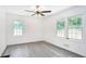 Light and airy bedroom with two windows and modern ceiling fan at 3132 Lunsford Cir, Covington, GA 30014
