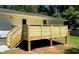 New wooden deck and stairs leading to a flat, grassy backyard at 3132 Lunsford Cir, Covington, GA 30014