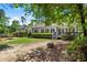 Well-maintained backyard featuring a spacious lawn, mature trees, and a cozy patio area at 6250 Bannerhorn Run, Alpharetta, GA 30005