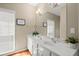 Bright bathroom featuring double sink vanity, granite countertops, and modern lighting fixtures at 6250 Bannerhorn Run, Alpharetta, GA 30005