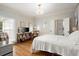 Well-lit bedroom with wood floors, wallpapered walls, window, and access to a closet at 6250 Bannerhorn Run, Alpharetta, GA 30005