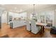Bright dining area with large windows, modern lighting, and a view of the backyard at 6250 Bannerhorn Run, Alpharetta, GA 30005