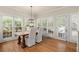 Sunlit dining area featuring plantation shutters, hardwood floors, and outdoor access at 6250 Bannerhorn Run, Alpharetta, GA 30005