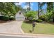 Attractive home exterior with a well-kept lawn, driveway, and lush landscaping at 6250 Bannerhorn Run, Alpharetta, GA 30005