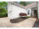 Charming home exterior with a well-manicured lawn, stone pathway, and inviting front entrance at 6250 Bannerhorn Run, Alpharetta, GA 30005