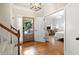 Warm foyer featuring hardwood floors, leading to a bedroom and living spaces at 6250 Bannerhorn Run, Alpharetta, GA 30005