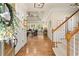Bright foyer leading into a spacious living area with hardwood floors and a view of the backyard at 6250 Bannerhorn Run, Alpharetta, GA 30005