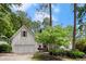 Charming home featuring a two-car garage, manicured lawn, and mature landscaping at 6250 Bannerhorn Run, Alpharetta, GA 30005