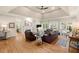 Spacious living room with hardwood floors, a fireplace, and large windows for natural light at 6250 Bannerhorn Run, Alpharetta, GA 30005