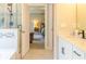Open bathroom showcasing a granite vanity, tile floor, and a view into the adjacent bedroom at 660 Stately Dr, Woodstock, GA 30188