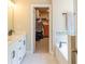 Bright primary bathroom featuring double sinks, a walk-in closet, and a soaking tub at 660 Stately Dr, Woodstock, GA 30188