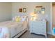 Cute bedroom features rainbow bedding, small decor, and a dresser at 660 Stately Dr, Woodstock, GA 30188