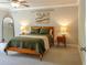 Calm bedroom with decorative wall art, a ceiling fan, and side tables with lamps at 660 Stately Dr, Woodstock, GA 30188